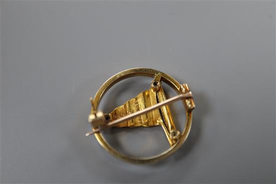 A 1950s 9ct gold and enamel set openwork circular pennant brooch, retailed by Benzies in Cowes, 22mm, gross 4.7 grams.